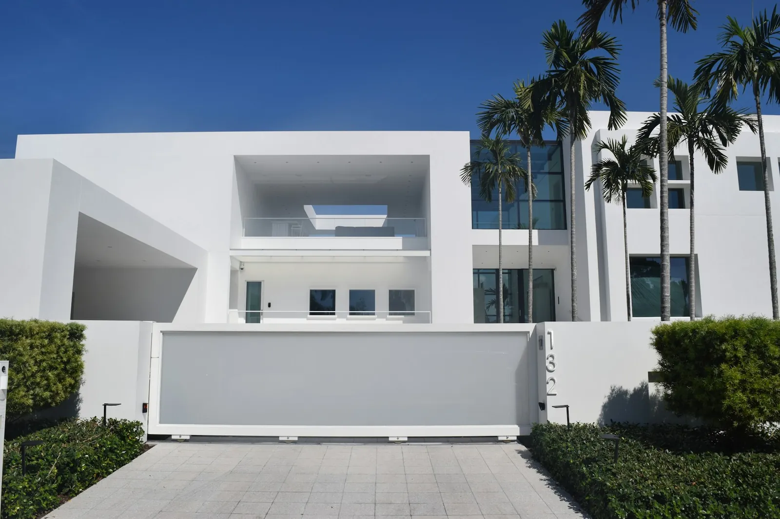 Modern white Florida home with palm trees