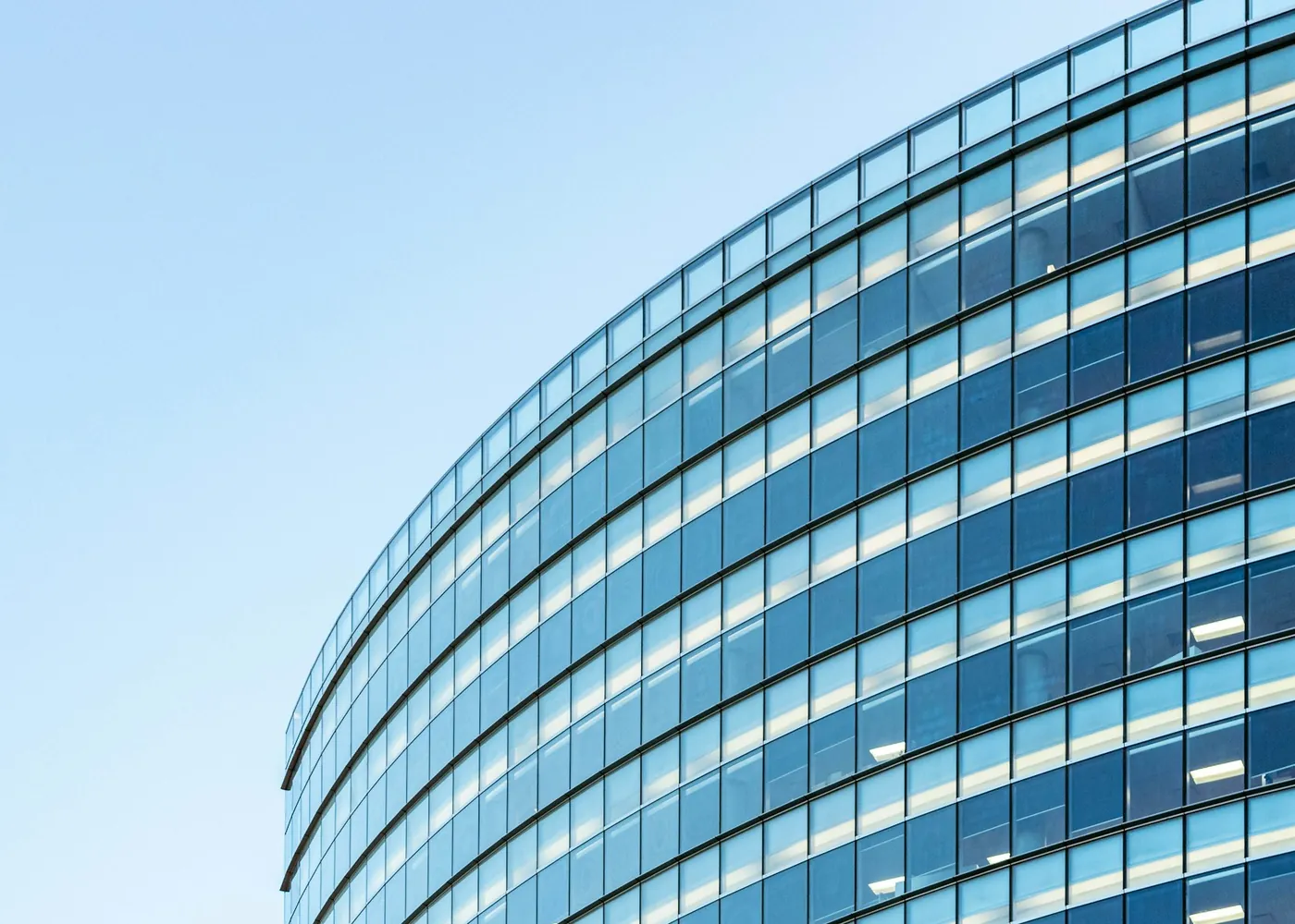 Curved glass facade of a modern commercial building