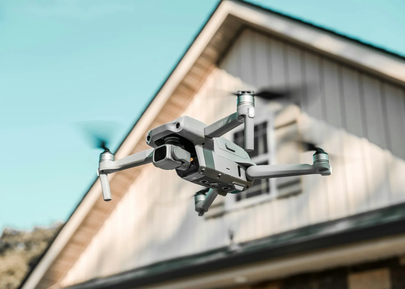 Drone flying next to the roof of a house